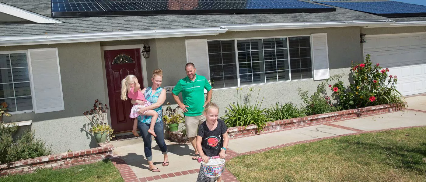 family leaving solar-powered house