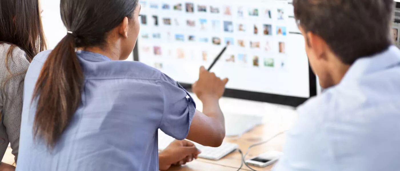 consultation with two people looking at a computer screen